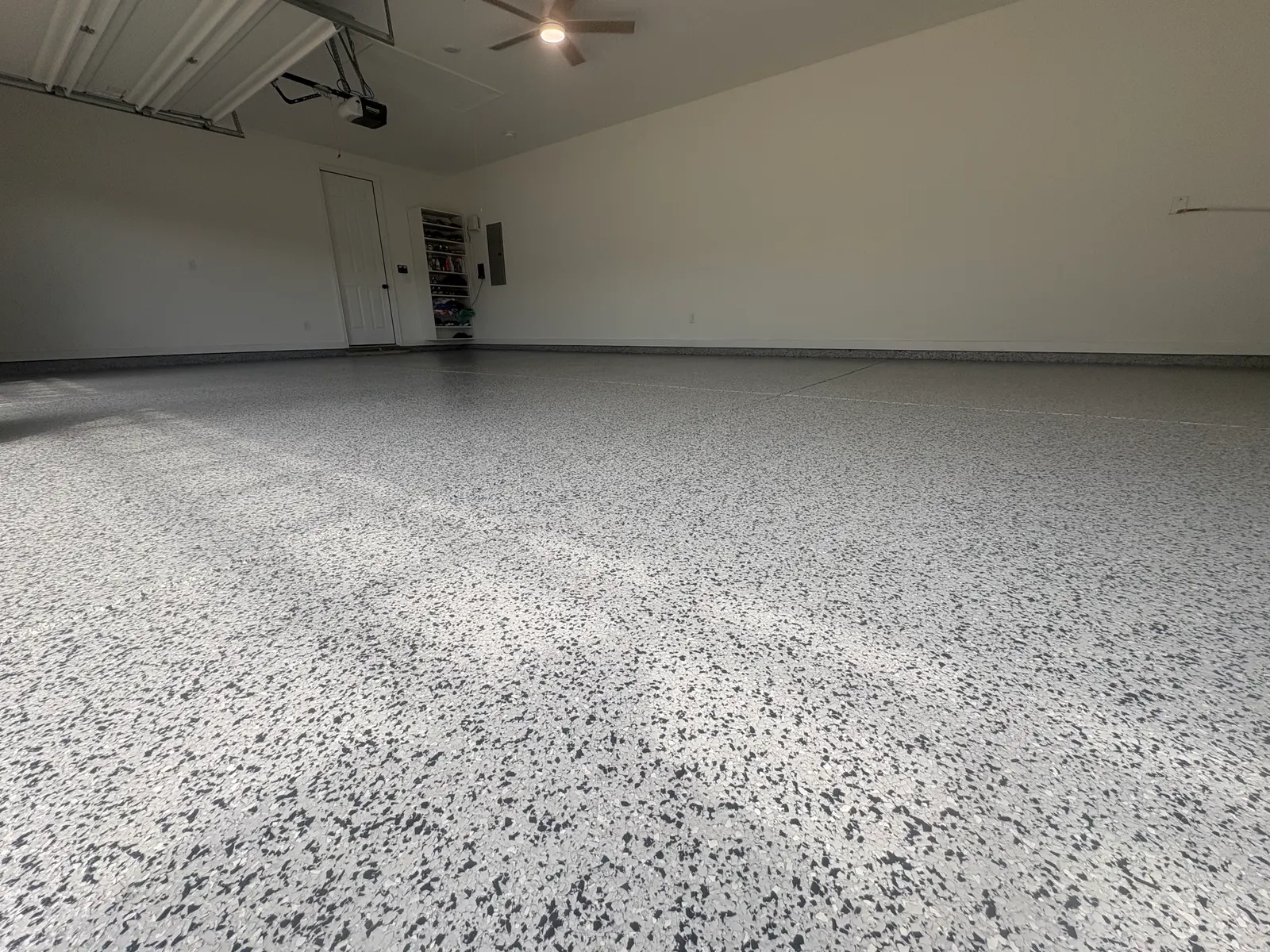 Two-car garage with a white, gray, and black flake-coated floor